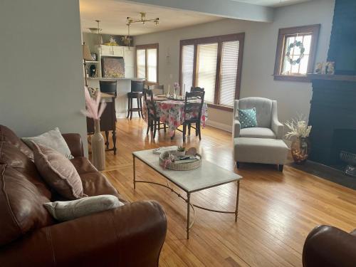 a living room with a couch and a table at Come home to Kenwood Conveniently located Syracuse in Syracuse