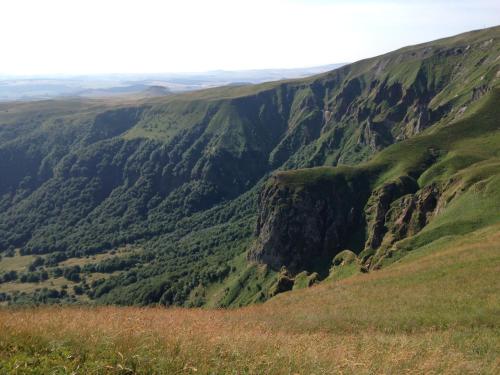 a view of the mountains from the top of a hill at Aux 500 Diables Eco Lodge - Hotel in Chambon-sur-Lac