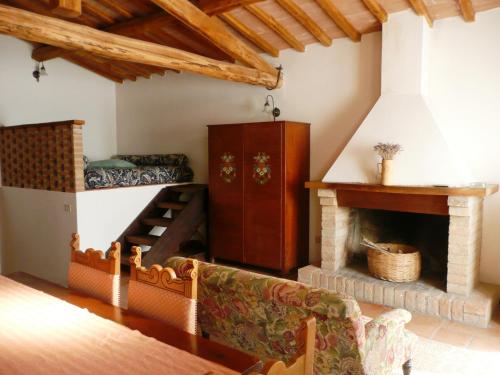 a living room with a couch and a fireplace at Marco & Andrea Agriturismo Collepina in Amelia