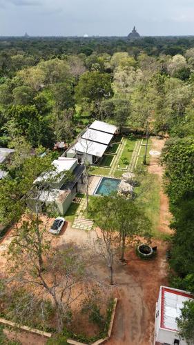 an aerial view of a house with a swimming pool at Maho Boutique Hotel in Anuradhapura