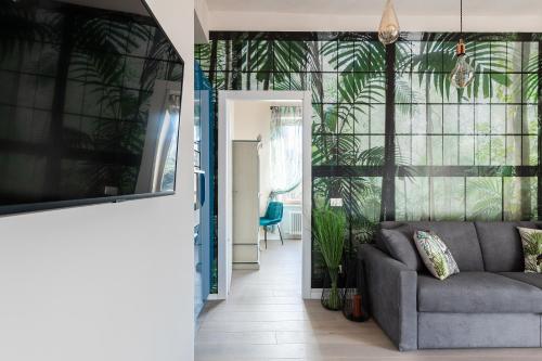 a living room with a couch and some plants at COMO BELLEVUE BORGHI in Como