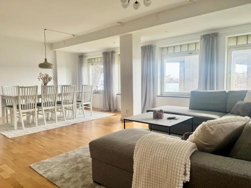 a living room with a couch and a table at Apartment with amazing view in Stockholm