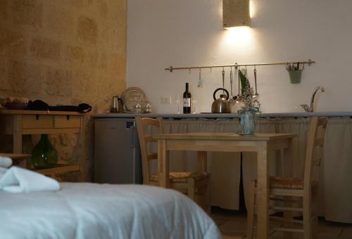 a kitchen with a table and a sink and a table and chairs at Bed & Breakfast Casa Lopez in Barletta