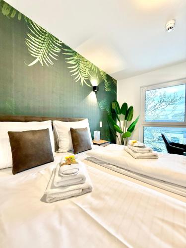 a large white bed with a towel on top of it at Apartment mit Balkon und Parkplatz in Vienna