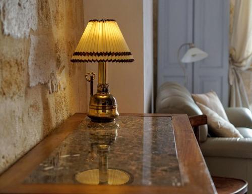 a table with a lamp on top of it at Bed & Breakfast Casa Lopez in Barletta