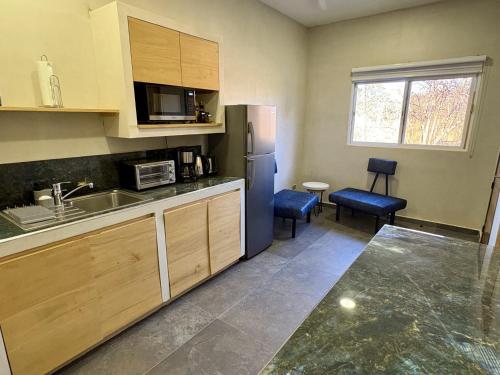a kitchen with a sink and a refrigerator at Pierre and Colors TAMARINDO Adults only in Tamarindo