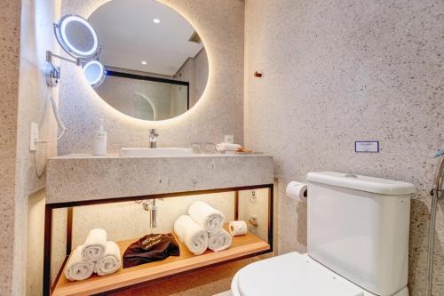 a bathroom with a sink and a toilet and a mirror at Radisson Blu São Paulo in Sao Paulo