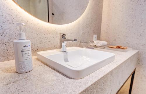a bathroom sink with a bottle of soap on it at Radisson Blu São Paulo in Sao Paulo
