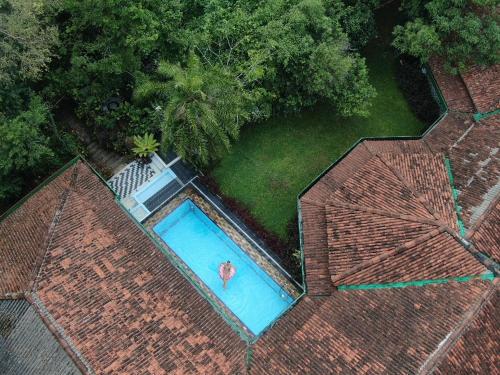 an overhead view of a swimming pool with a person in it at Kandahena Mansion in Akuressa