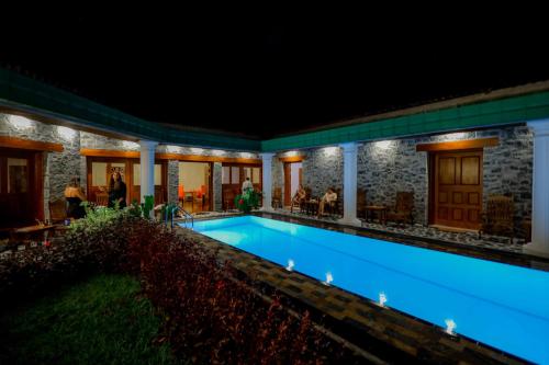 a swimming pool in a house at night at Kandahena Mansion in Akuressa