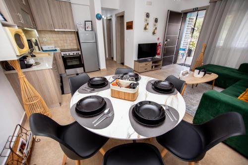 a kitchen and a dining room with a table and chairs at LUNA'S HOUSE in Asprovalta