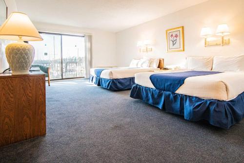 a hotel room with two beds and a large window at Harbourside II Condos in New Bern