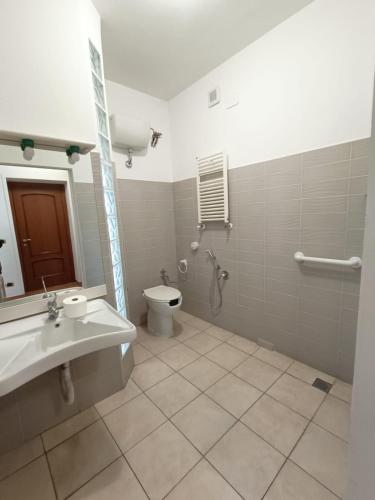 a bathroom with a toilet and a sink at OSTELLO del Lago in Grottaferrata