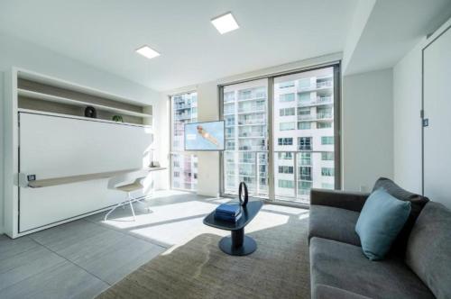 a living room with a couch and a large window at Spacious Studio in the Heart of Downtown Miami in Miami