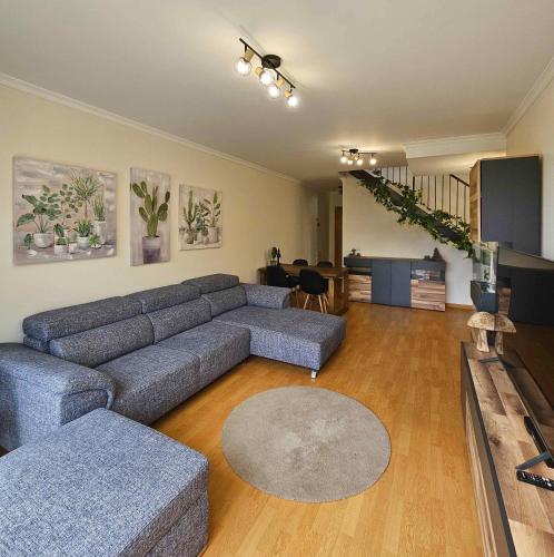 a living room with a couch and a table at A SELVA T2 in Caniço in Caniço