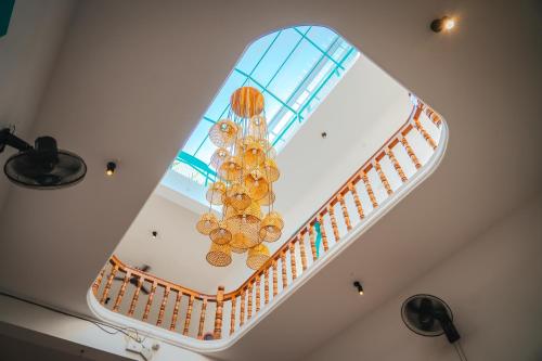 a spiral staircase with a chandelier in a building at Cliff and Coral Varkala, North Cliff in Varkala