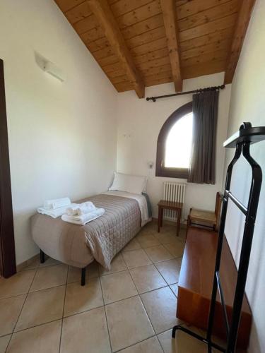 a bedroom with a bed in a room with a window at Il Ghiandolino in Imola