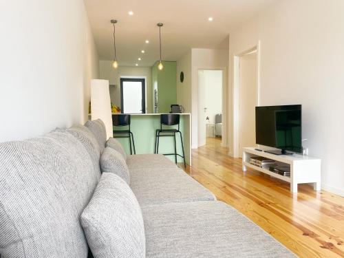 a living room with a couch and a television at Modern Retreat with Mountain Views in Covilhã