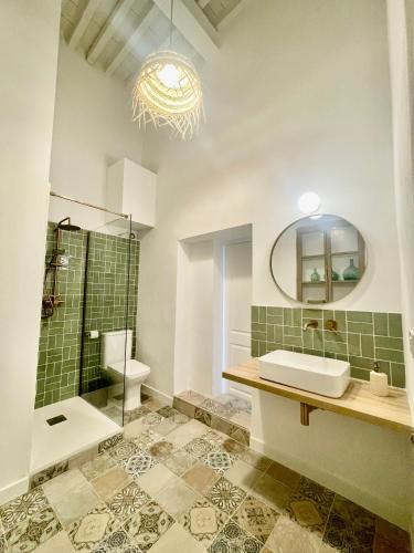 a bathroom with a sink and a toilet and a mirror at La Botica Home in Níjar