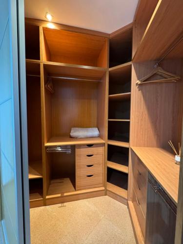 a walk in closet with wooden shelves and cabinets at Ático Luz del Valle in Dúrcal