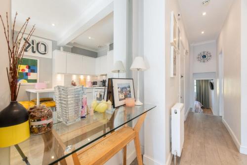 a dining room with a glass counter top at Stylish flat in West Hampstead in London