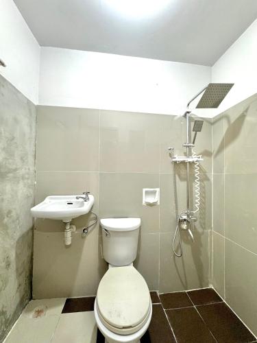 a bathroom with a toilet and a sink at ACE Condo in Cebu City
