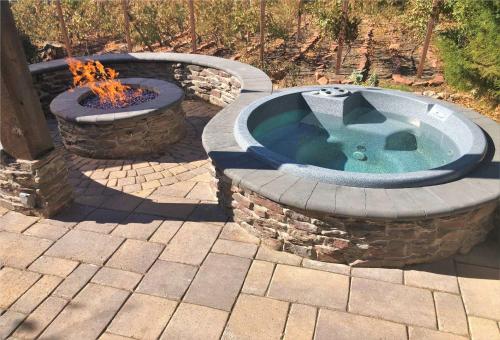 a hot tub with a fire pit in a yard at 6-Bedroom Tudor in the Downtown Historic District in Salt Lake City