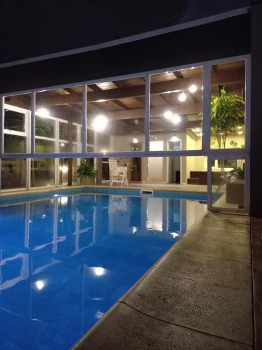 a large swimming pool in a building at night at Valeria House Rental Suites in Valeria del Mar