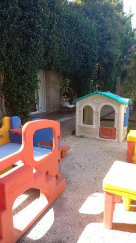 a group of plastic play sets in a yard at Valeria House Rental Suites in Valeria del Mar