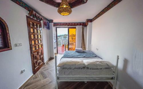 a bed in a room with a large window at Tangiers Hostel in Tangier
