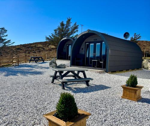 a tent with a picnic table in front of it at Stoer Pods - Suilven Pod in Lochinver