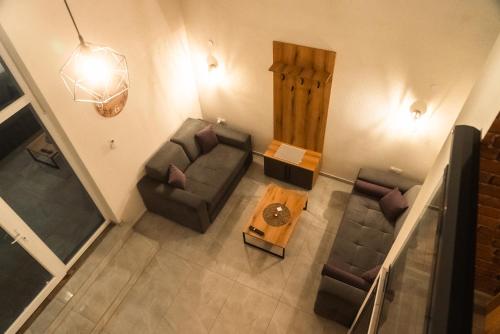 an overhead view of a living room with couches and a table at Bakery apartments in Perea
