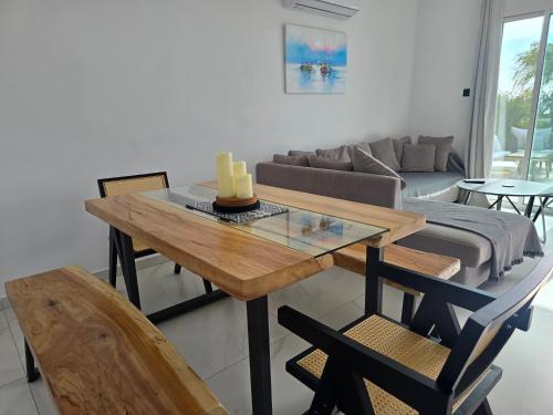 a living room with a table and a couch at Villa Amavi Peyia in Peyia