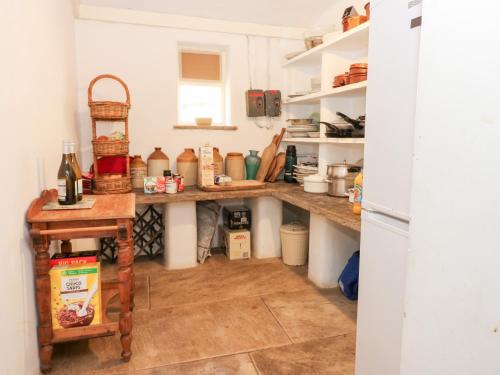 a kitchen with a counter with lots of food at Sycamore Tree Farm in Outhgill