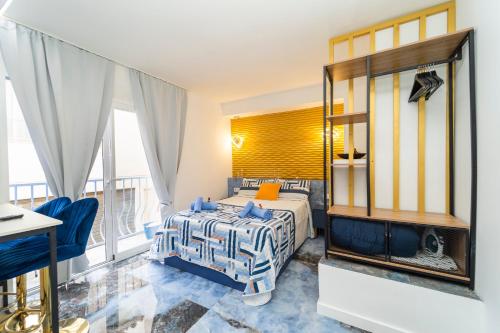 a bedroom with a bed and a large window at Apartamentos Brisas del Poniente in Benidorm