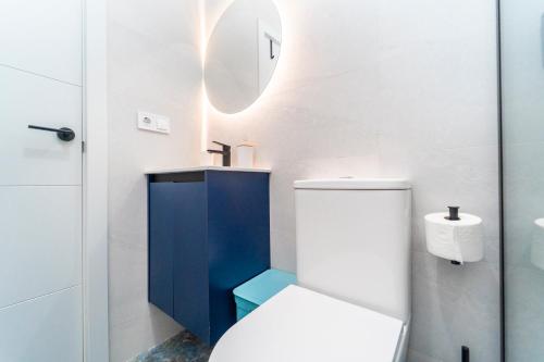 a bathroom with a toilet and a sink and a mirror at Apartamentos Brisas del Poniente in Benidorm