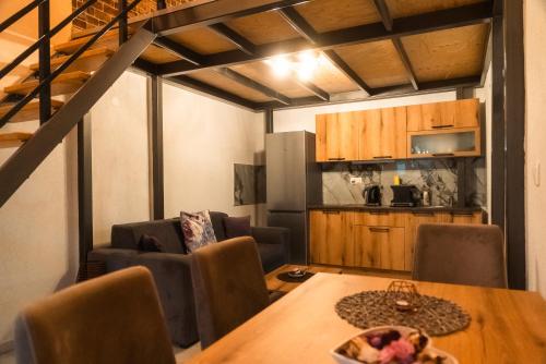 a kitchen and dining room with a table and chairs at Bakery apartments in Perea