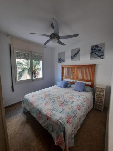 a bedroom with a bed and a ceiling fan at Eucalytus I in Salou
