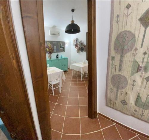 a room with a dining room with a table at Domo Rosada in Ottava Sassari