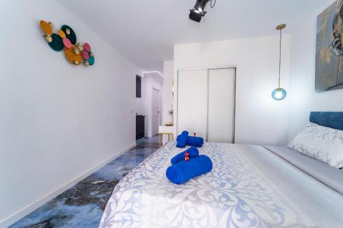 a bedroom with a large bed with blue pillows on it at Apartamentos Brisas del Poniente in Benidorm