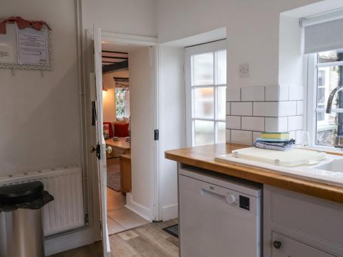 une cuisine avec un comptoir et un évier dans l'établissement Hope Cottage, à Beer