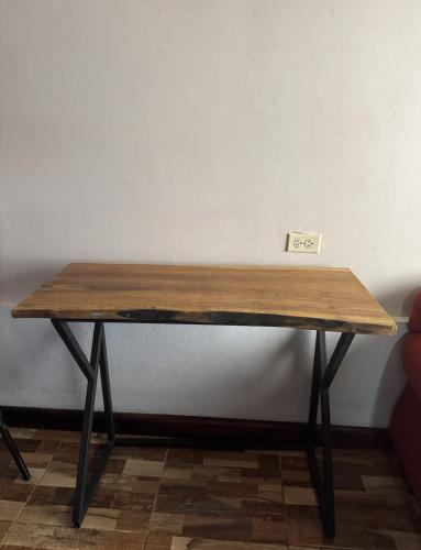 a wooden table sitting in a room next to a wall at La Cabaña de Merce in Tanque