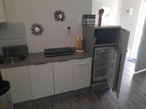 a kitchen with a counter with a sink and a stove at Family House in Beauvais