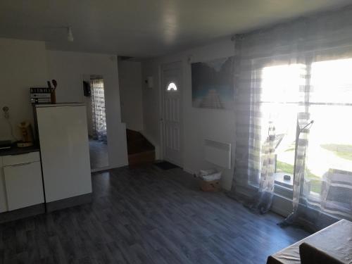 a kitchen and living room with a large window at Family House in Beauvais