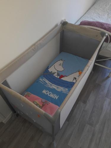 a bed with a box with a cat on it at Family House in Beauvais