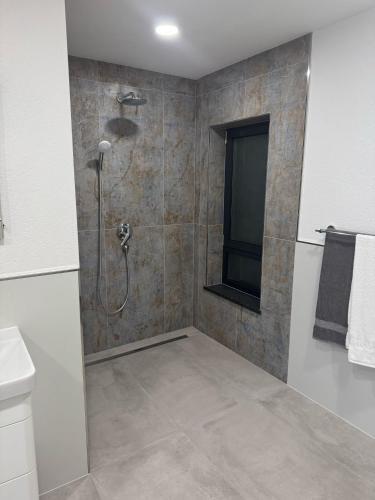 a bathroom with a shower and a sink at Villa Karla Luxury Pool Villa near Šibenik & Krka in Konjevrate