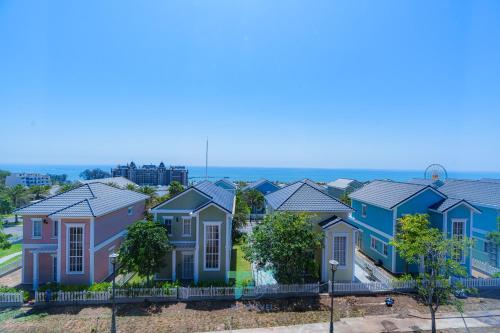 a row of houses with the ocean in the background at DT Retreat - Biệt thự nguyên căn - 3 Phòng ngủ - Novaworld Phan Thiết in Phan Thiet