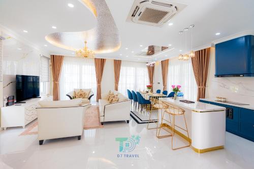 a kitchen and living room with blue and white furniture at DT Retreat - Biệt thự nguyên căn - 3 Phòng ngủ - Novaworld Phan Thiết in Phan Thiet