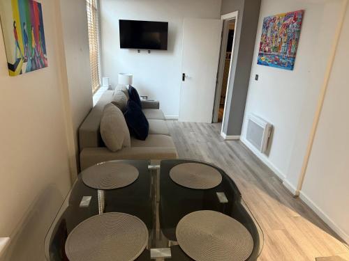 a living room with a couch and two tables at 5 Halifax House Apartment 7 in Liverpool