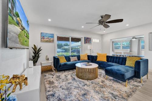 a living room with a blue couch and a table at Private Room in Spacious 3-Bedroom Home in Fort Lauderdale
